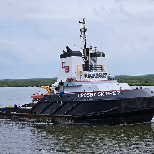 A tugboat underway on a waterway.