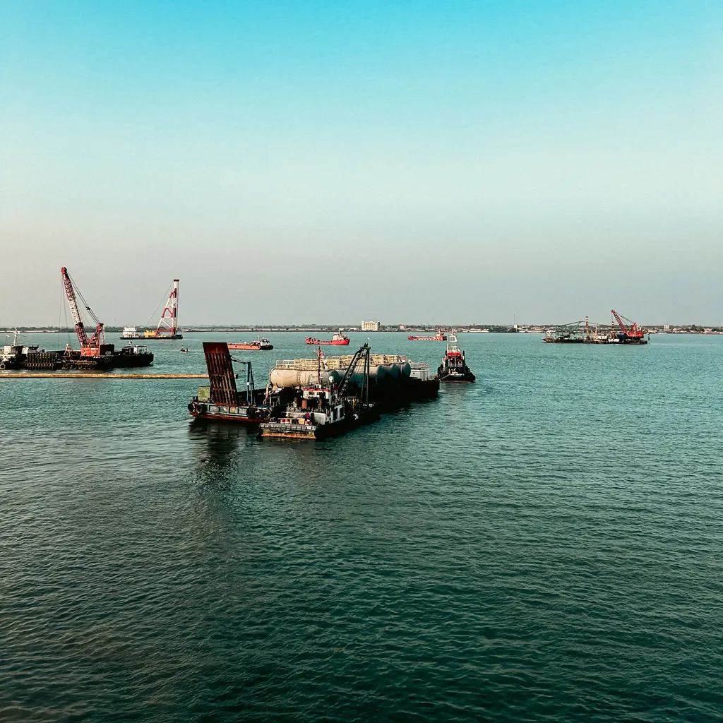 Marine construction vessels and crane barges gathered in a harbor.