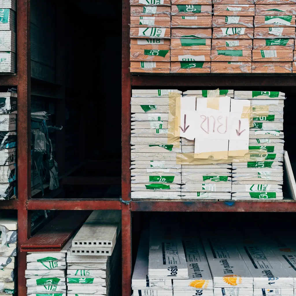 Stacks of wrapped boards and building materials on tall industrial shelves.