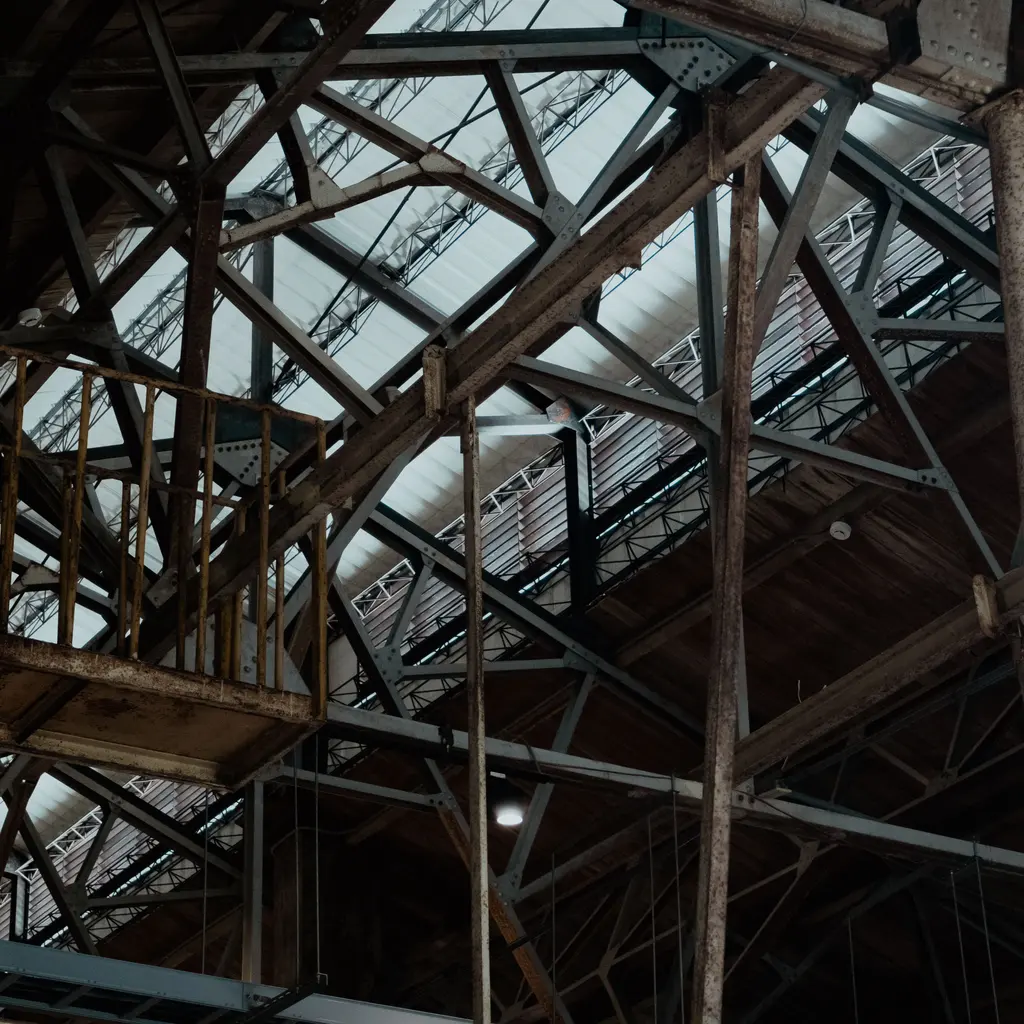 Steel trusses and roof framing inside an industrial warehouse.