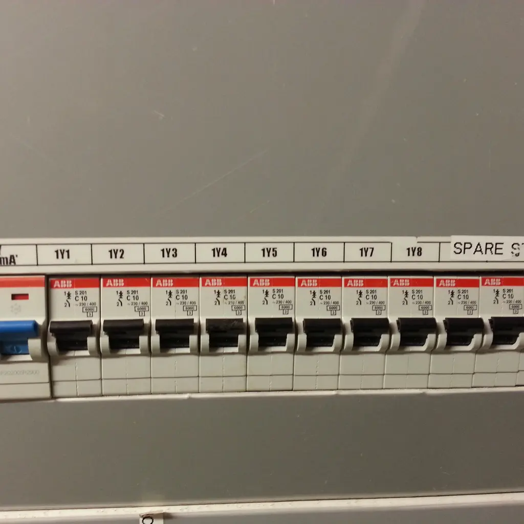 A row of miniature circuit breakers mounted in an electrical distribution panel.