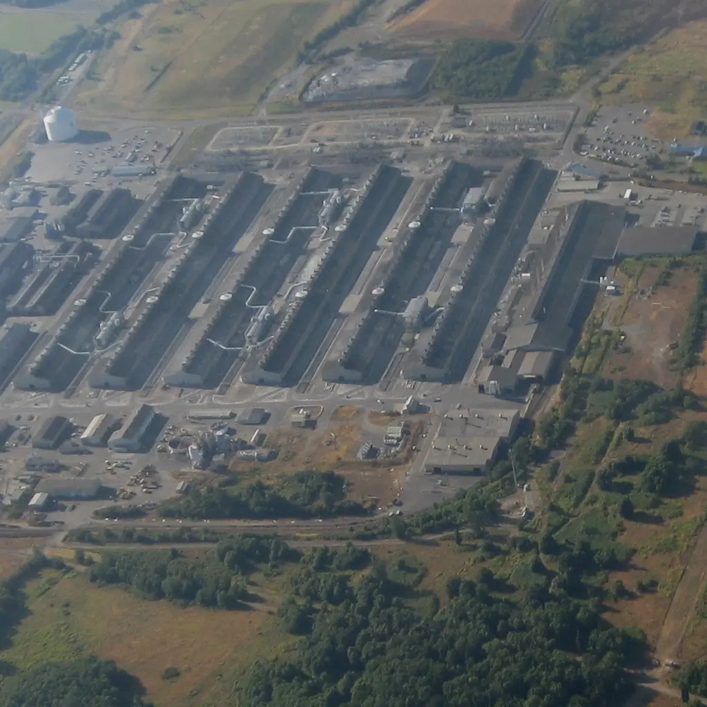 Long potline buildings and service roads at an aluminum smelter viewed from above.