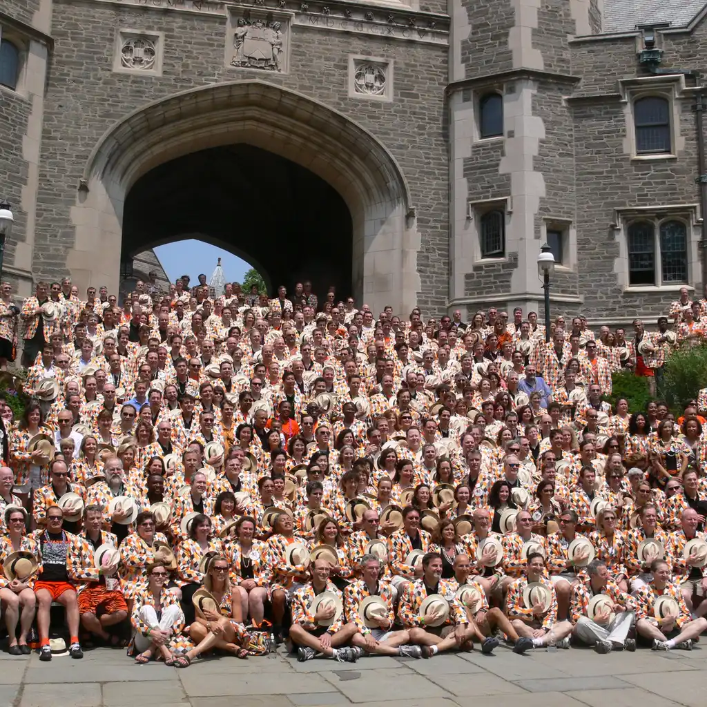 Alumni gathered for a class reunion outside a university building.