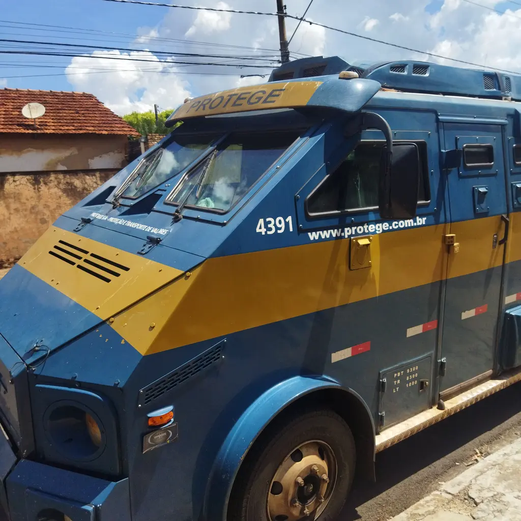 An armored cash-in-transit truck parked on a street.