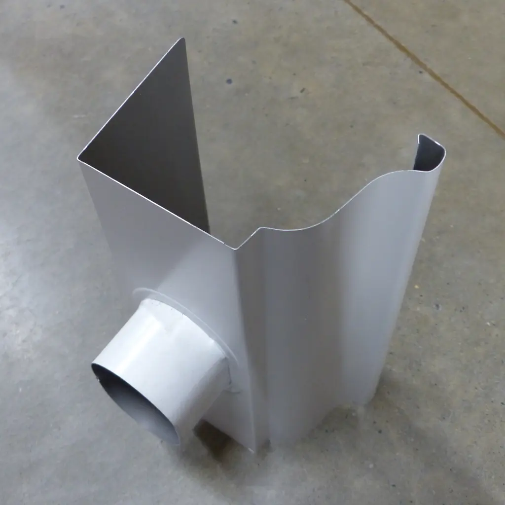 An aluminum K-style rain gutter section with a downspout outlet.