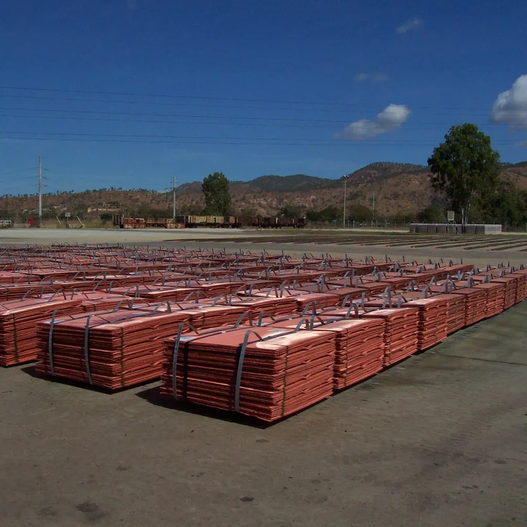 Bundles of refined copper cathode sheets stacked outdoors for shipment.