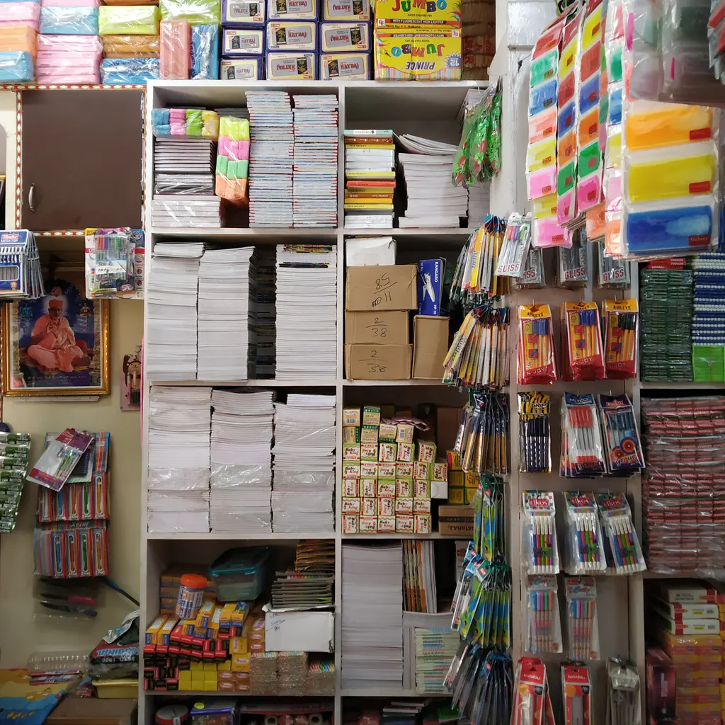 Stacks of notebooks and assorted stationery arranged on shelves.