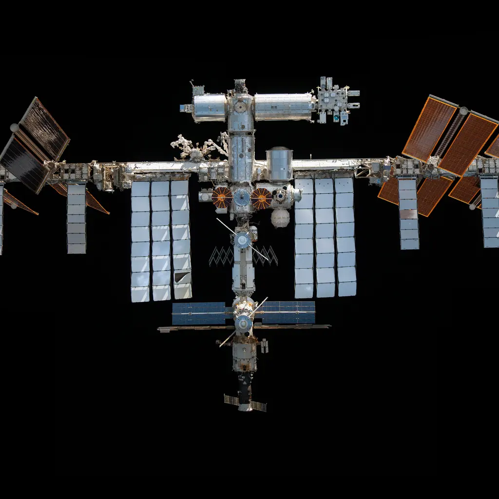 The International Space Station's connected laboratory modules, truss and solar arrays against black space.