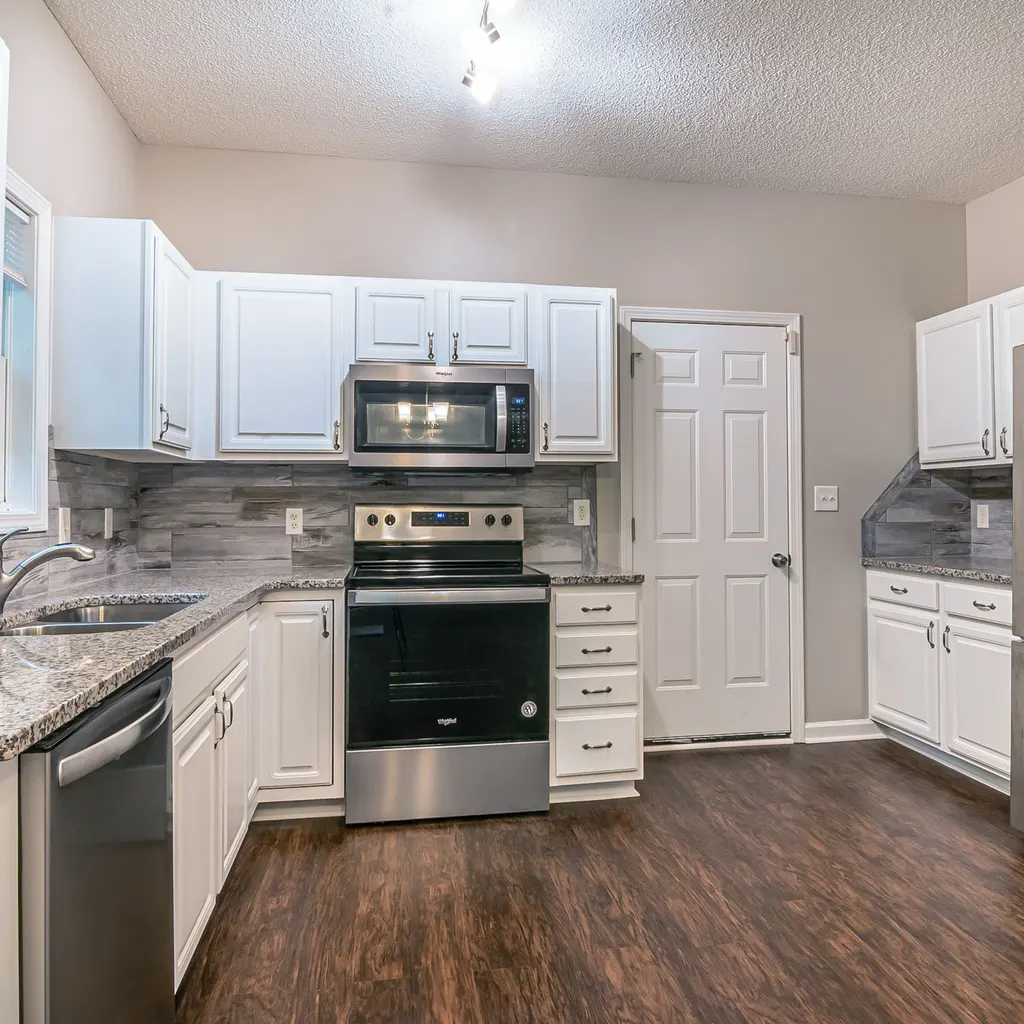 A stainless-steel range and microwave installed in a fitted kitchen.