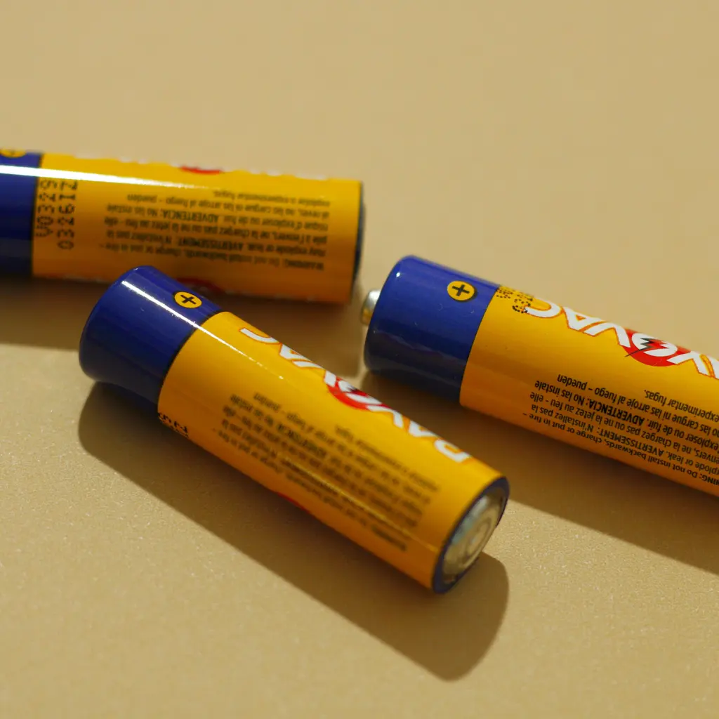 Three yellow-and-blue cylindrical batteries with their metal terminals visible.