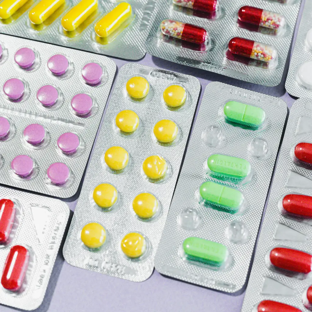 Assorted tablets and capsules sealed in unbranded blister packs.