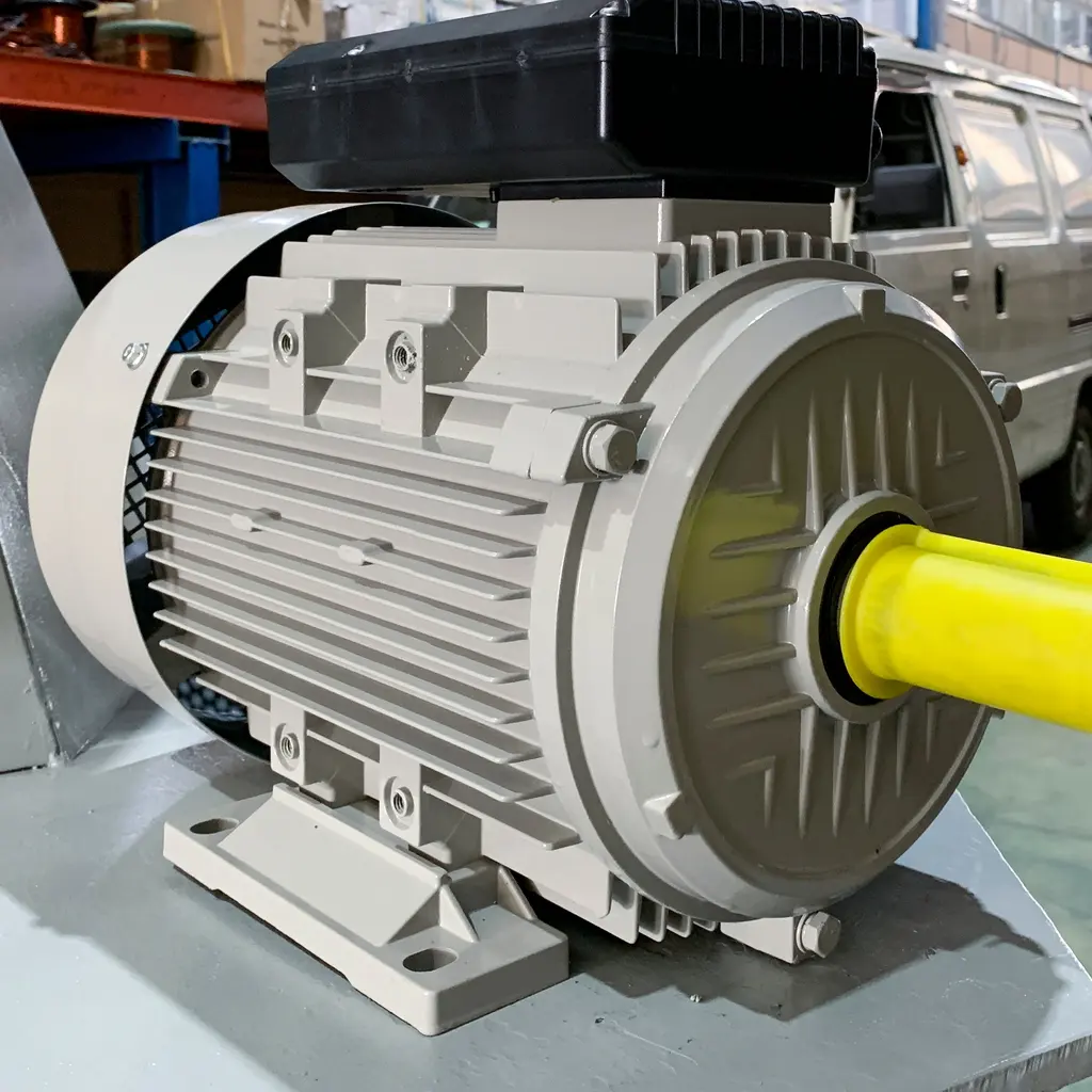 Ribbed housing and protected shaft of an industrial electric motor on a metal platform.