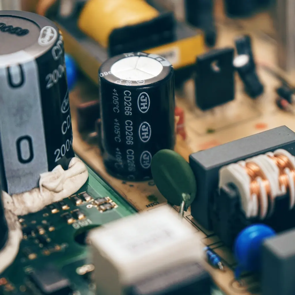 Close-up of capacitors, resistors and other electronic components on a circuit board.
