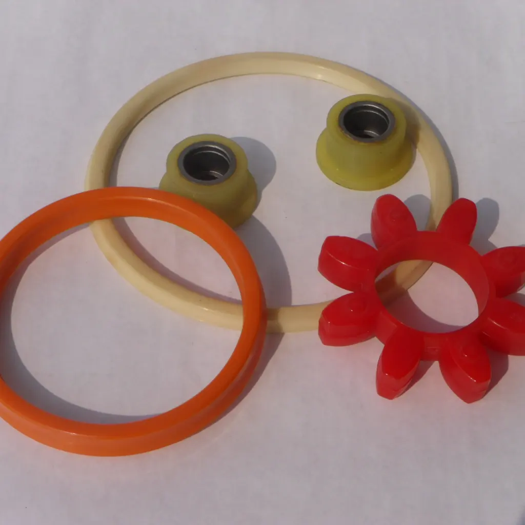 Assorted industrial sealing rings and molded seals arranged on a white surface.