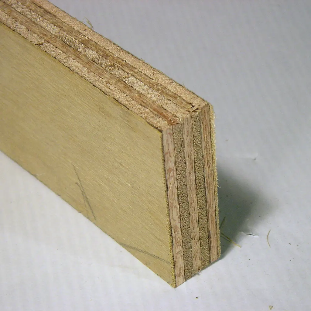 A close-up of plywood showing its laminated veneer layers and smooth outer face.