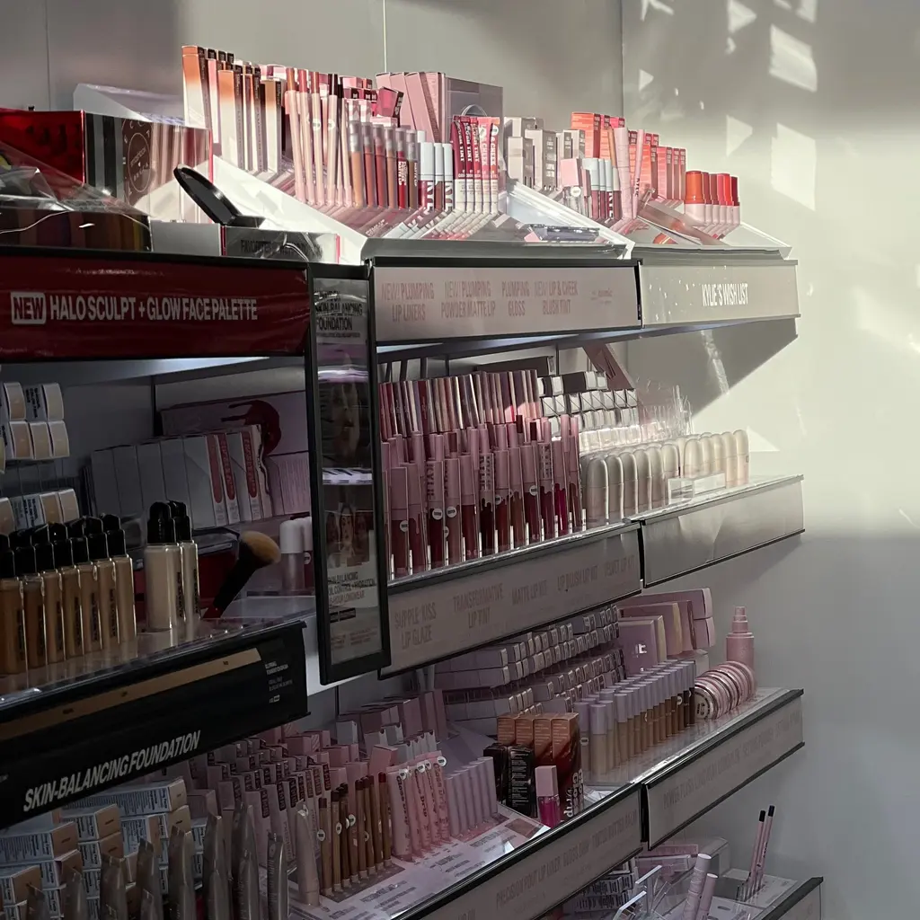 Makeup products fill several tiers of a cosmetics-store display.