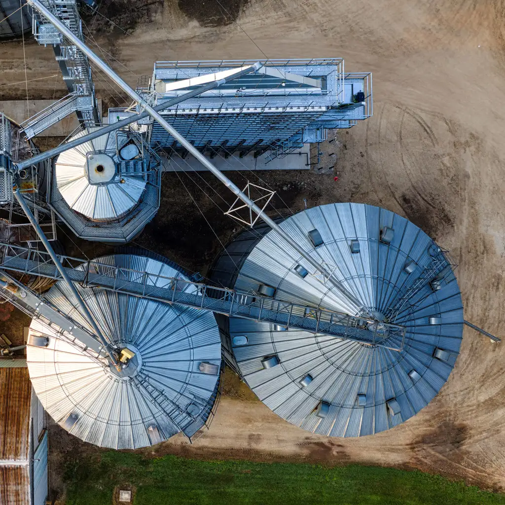 Overhead view of grain-storage roofs, connecting walkways and handling equipment.