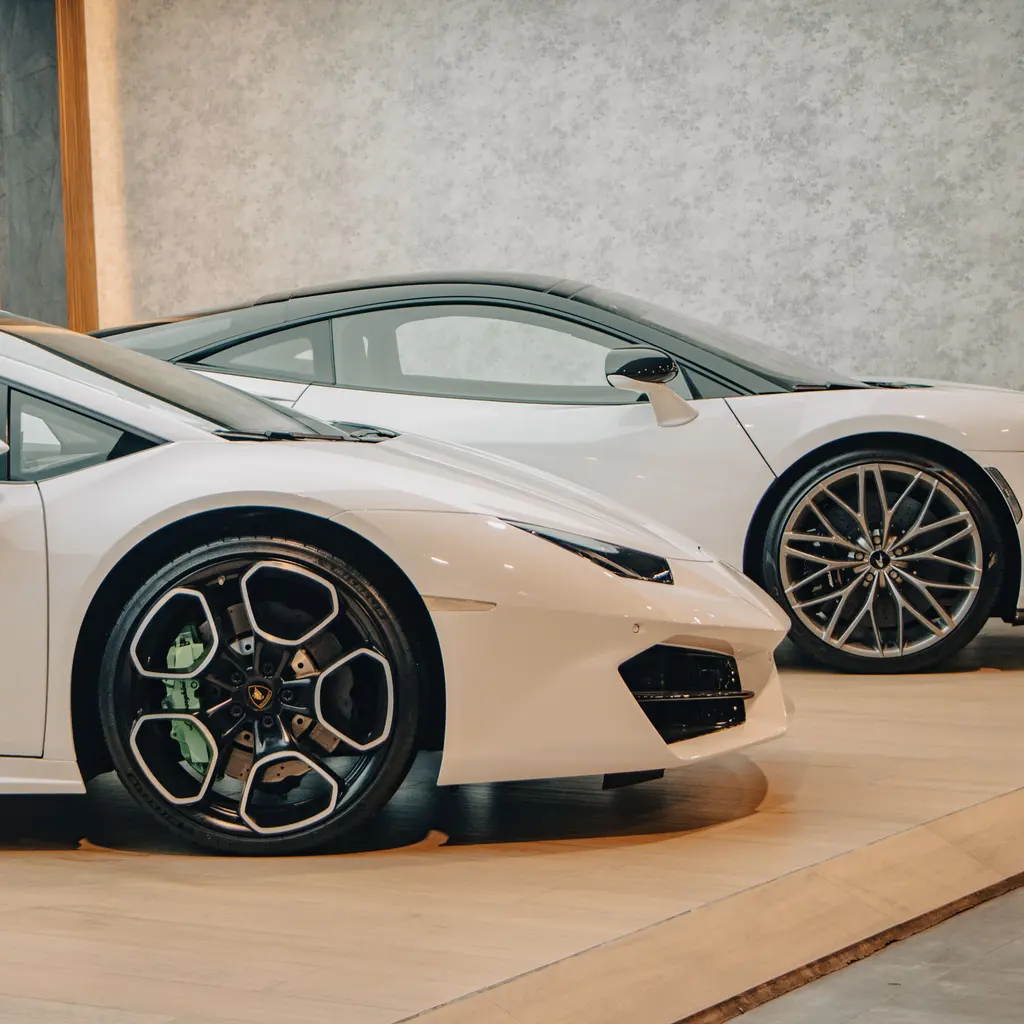Vehicles displayed together in an indoor showroom.