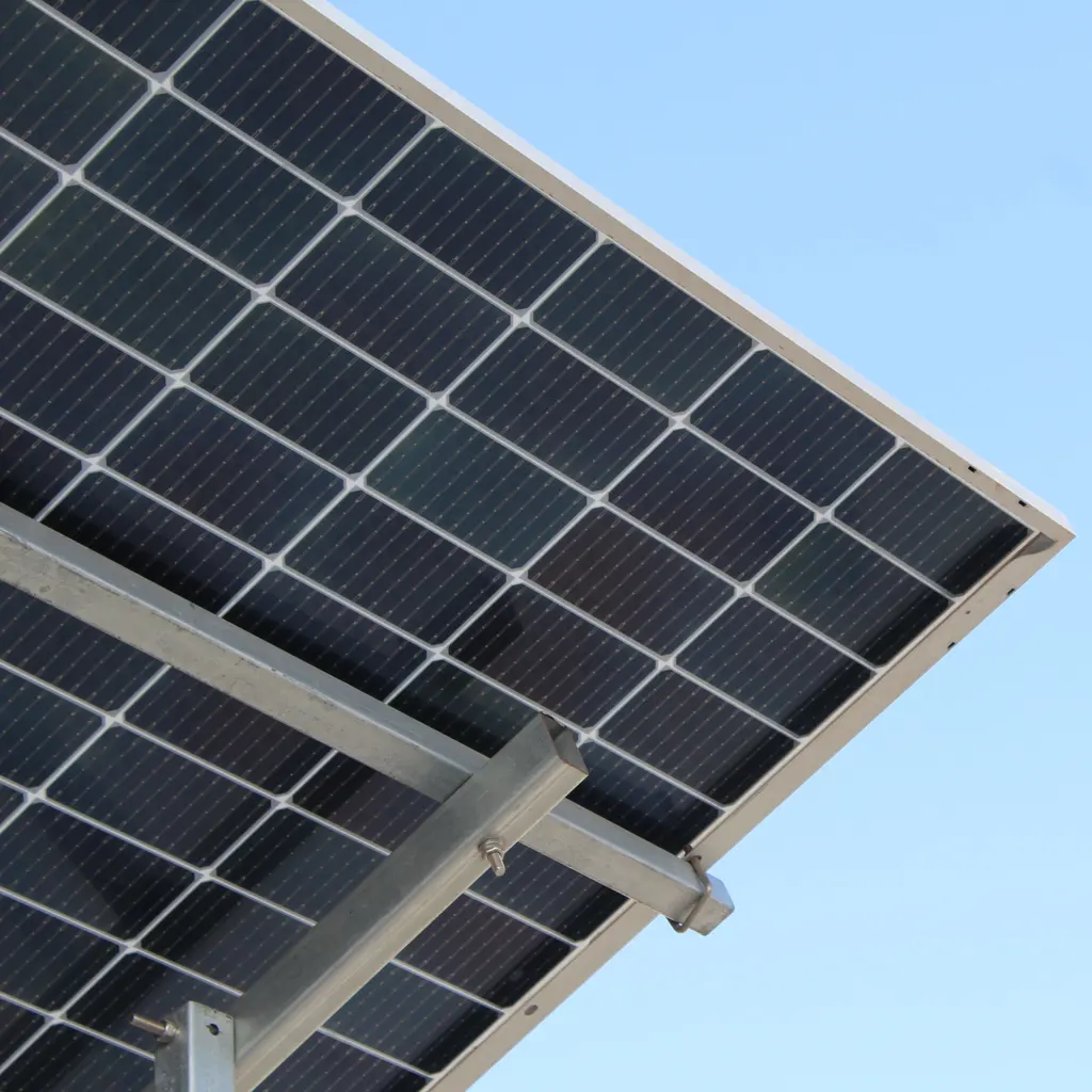 Solar panels mounted on a metal support frame beneath a clear sky.