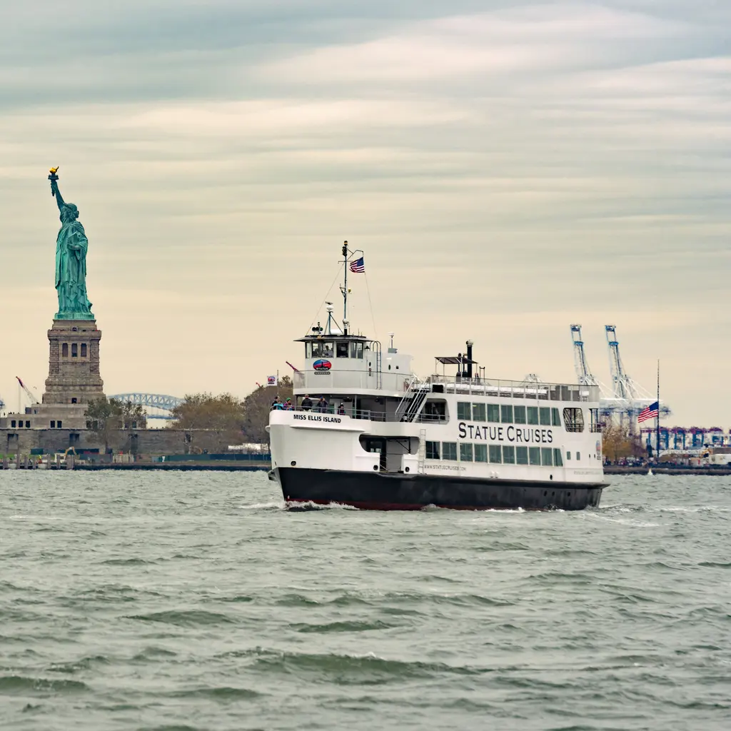 A sightseeing ferry passing the Statue of Liberty.