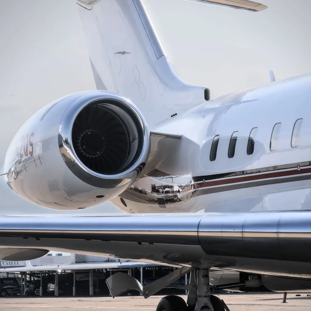 Rear-mounted engine and cabin windows on a parked business jet.