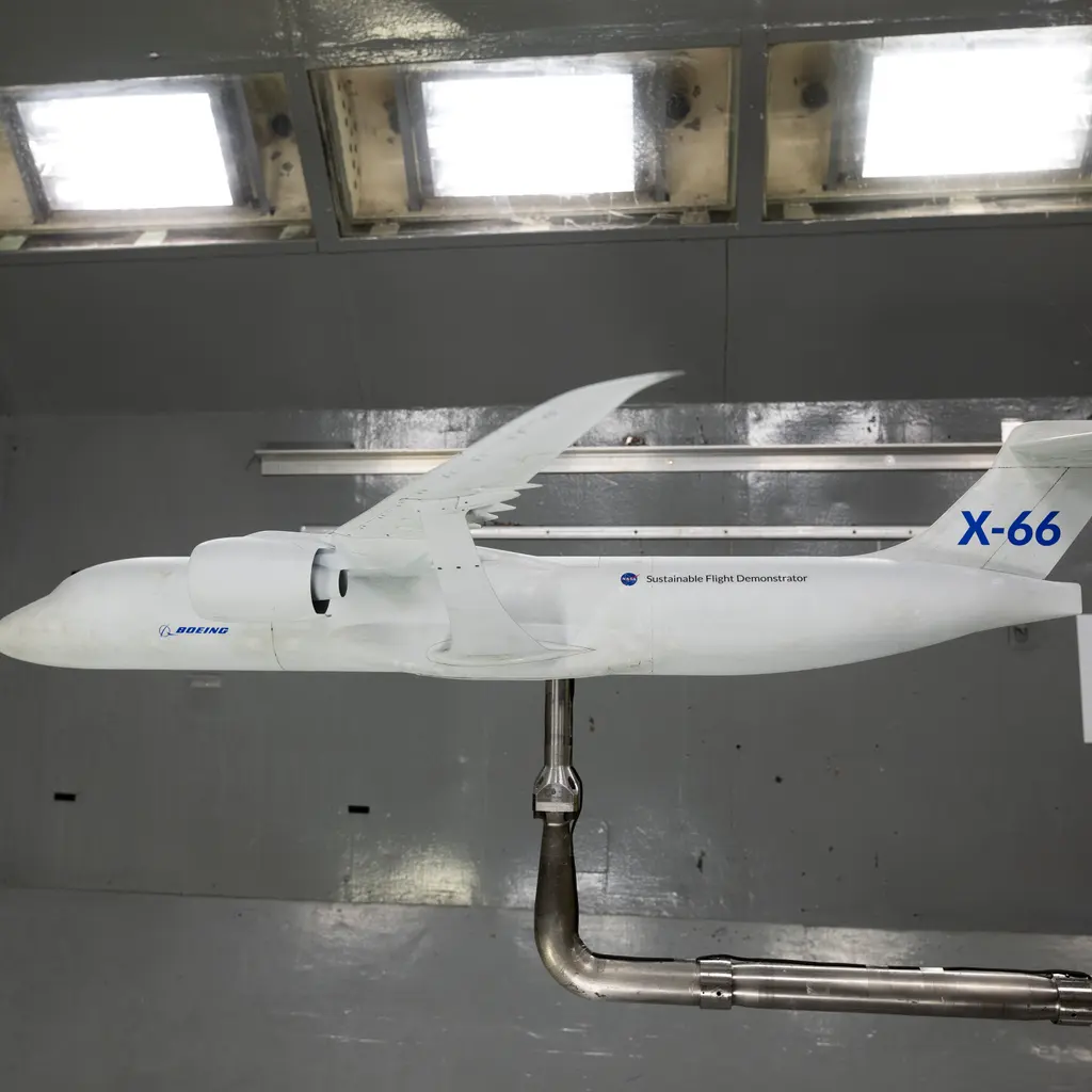 An experimental aircraft model mounted inside a wind-tunnel test chamber.