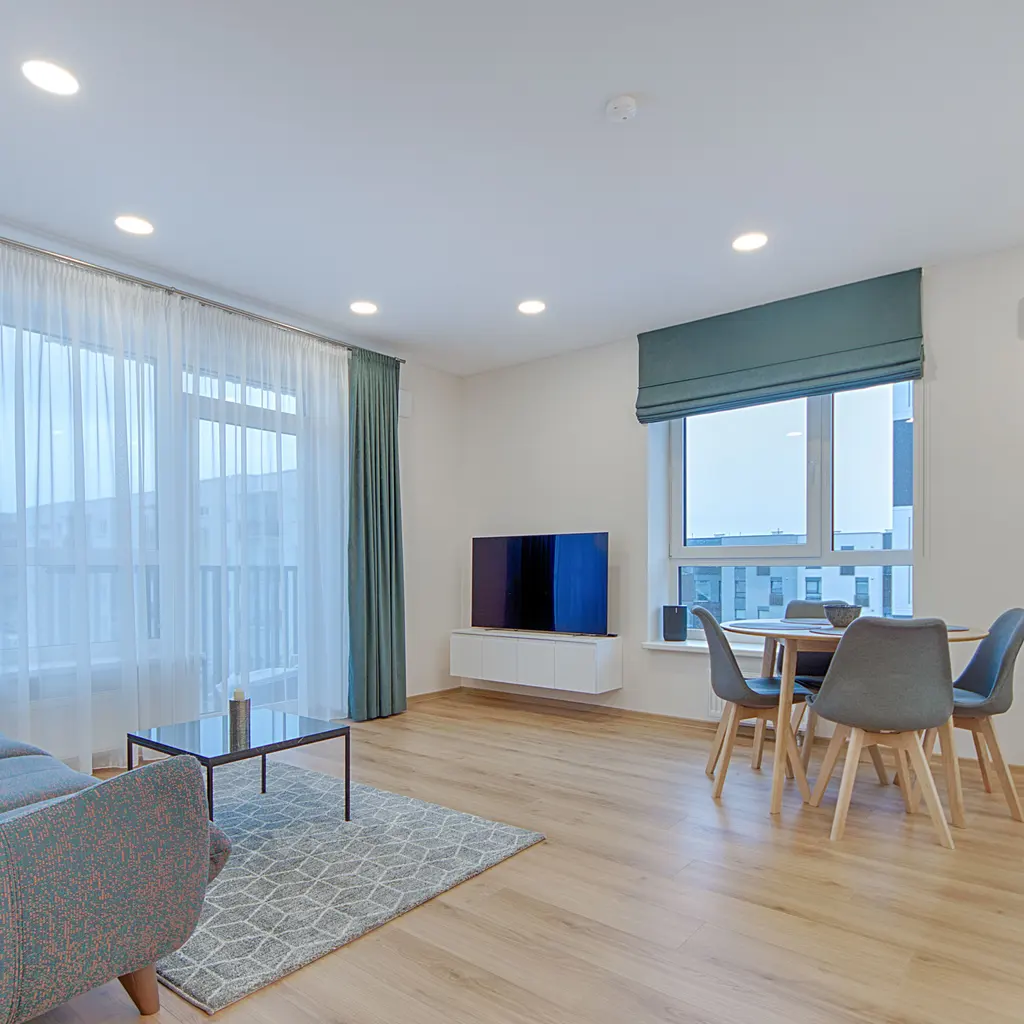 A bright furnished apartment living room and dining area.