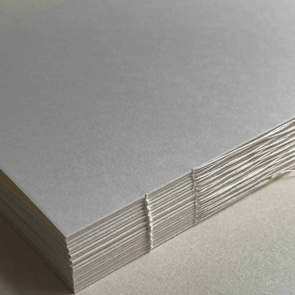 Folded paper signatures stitched together into a book block.