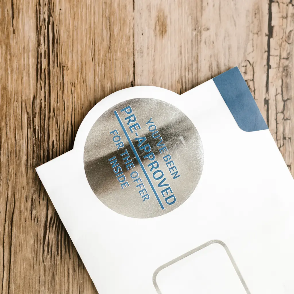 Printed promotional mail and a window envelope.