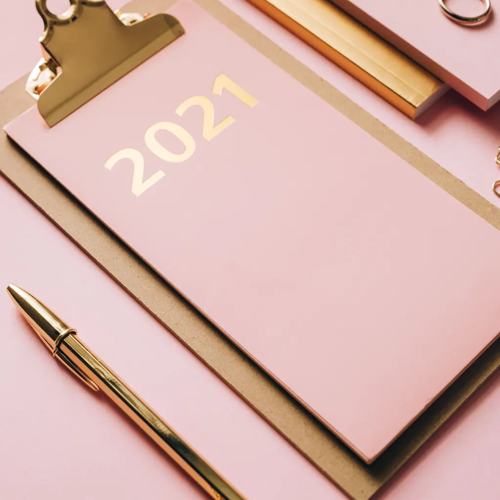 Gold-foil numerals on a pale pink planner cover.