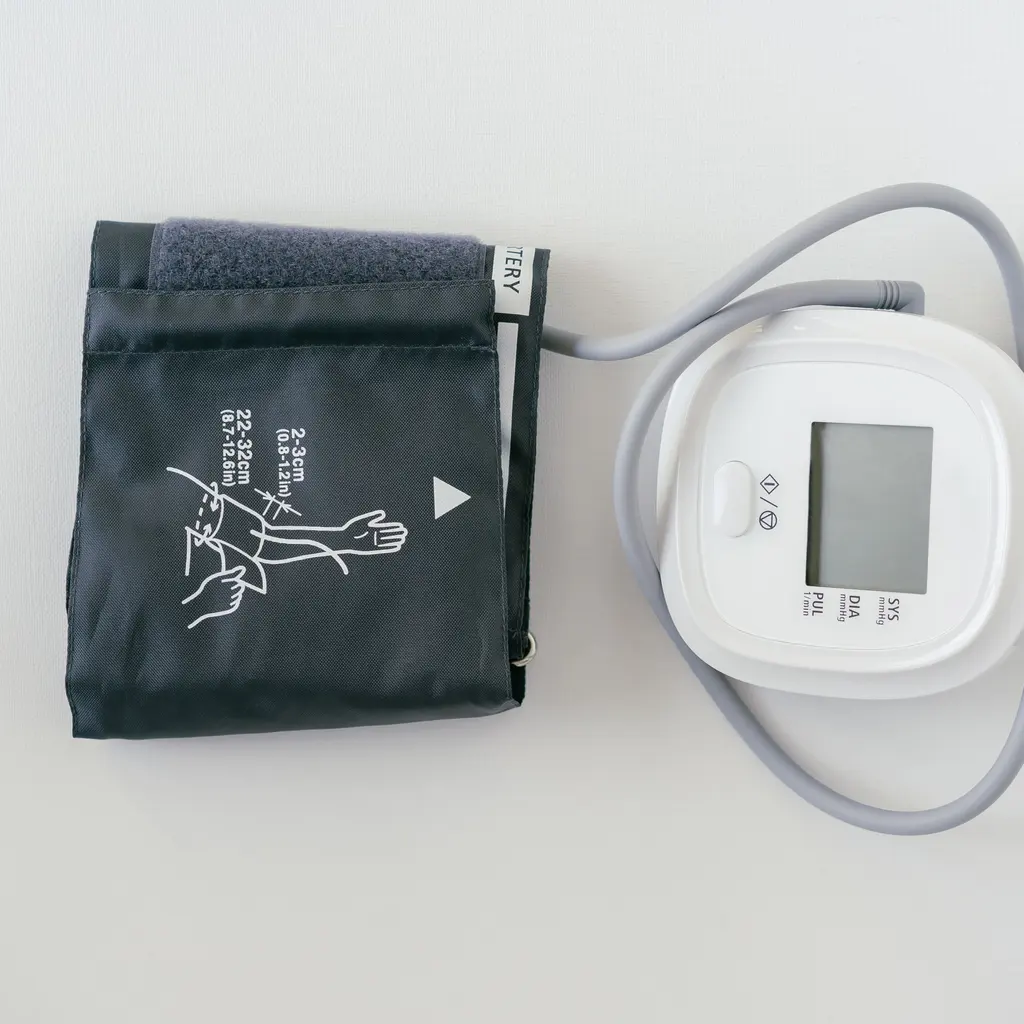 A digital blood-pressure monitor with its arm cuff.