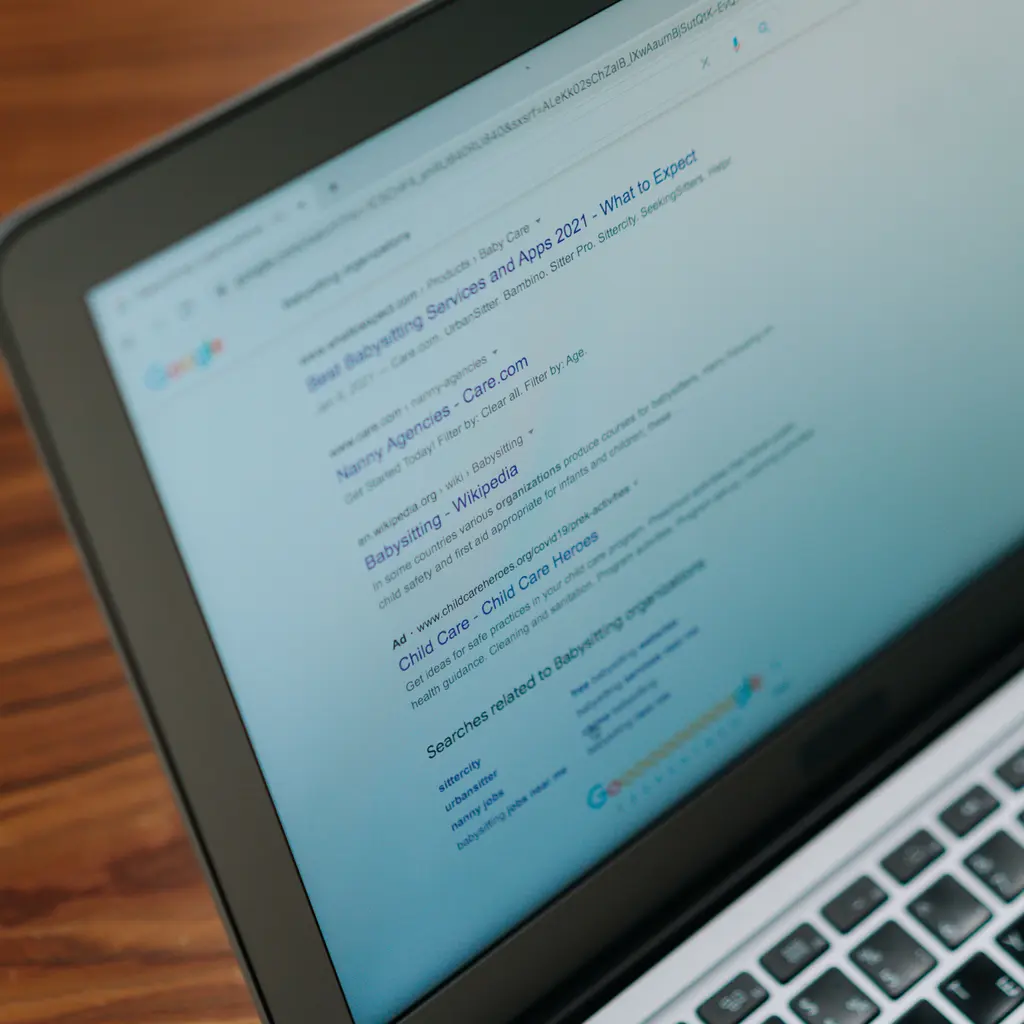 Search results displayed on a laptop.