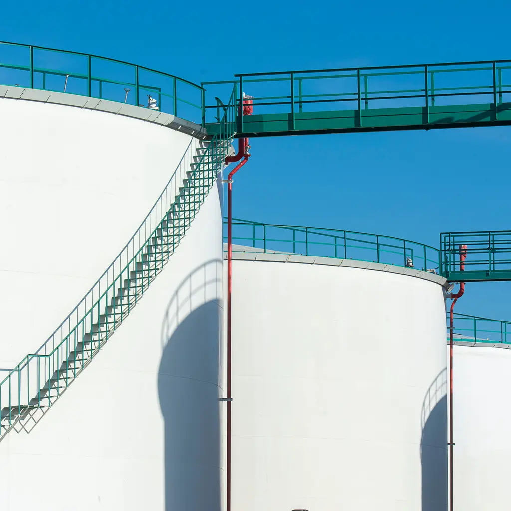 Large cylindrical storage tanks connected by elevated access walkways.
