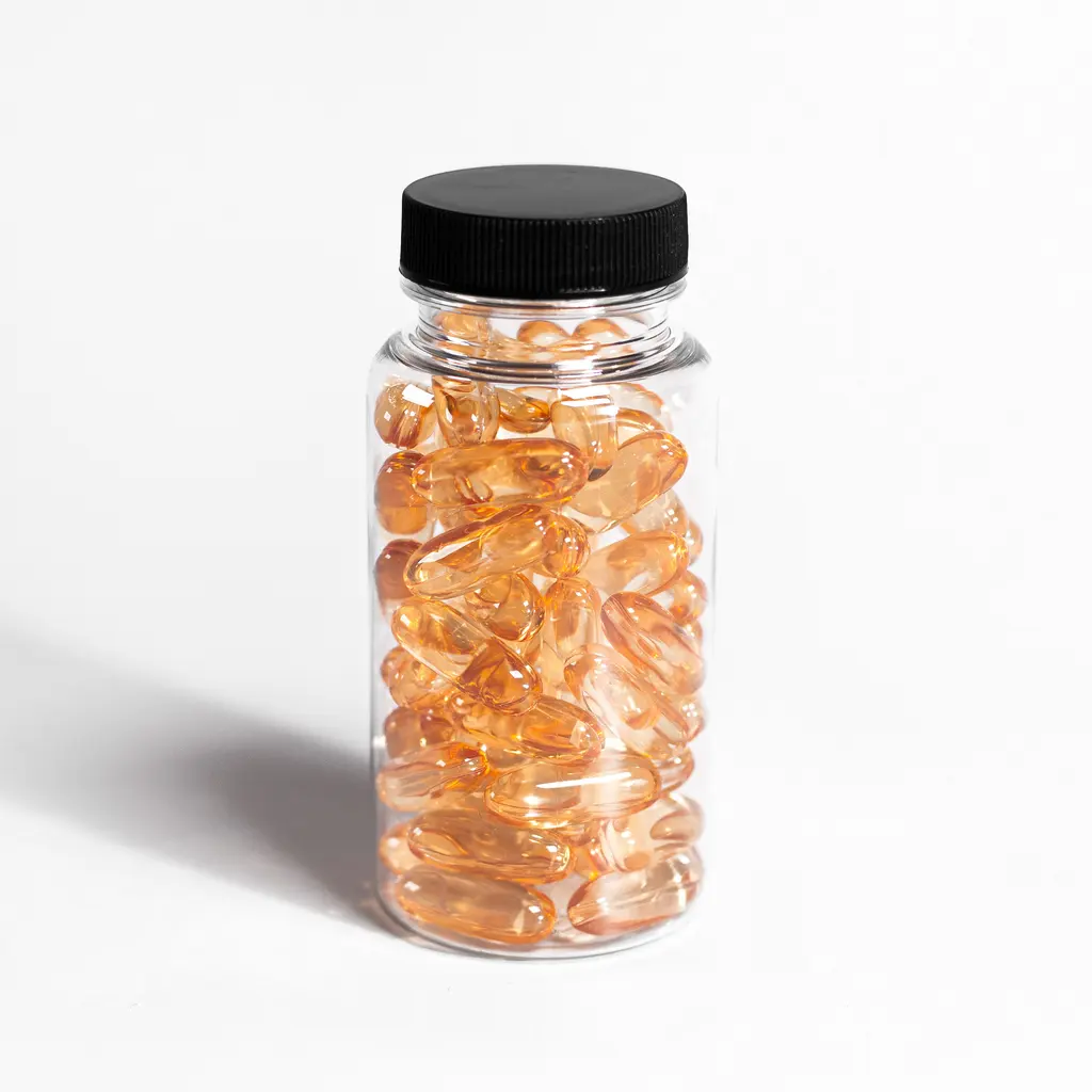 A clear bottle filled with amber-colored softgel capsules.