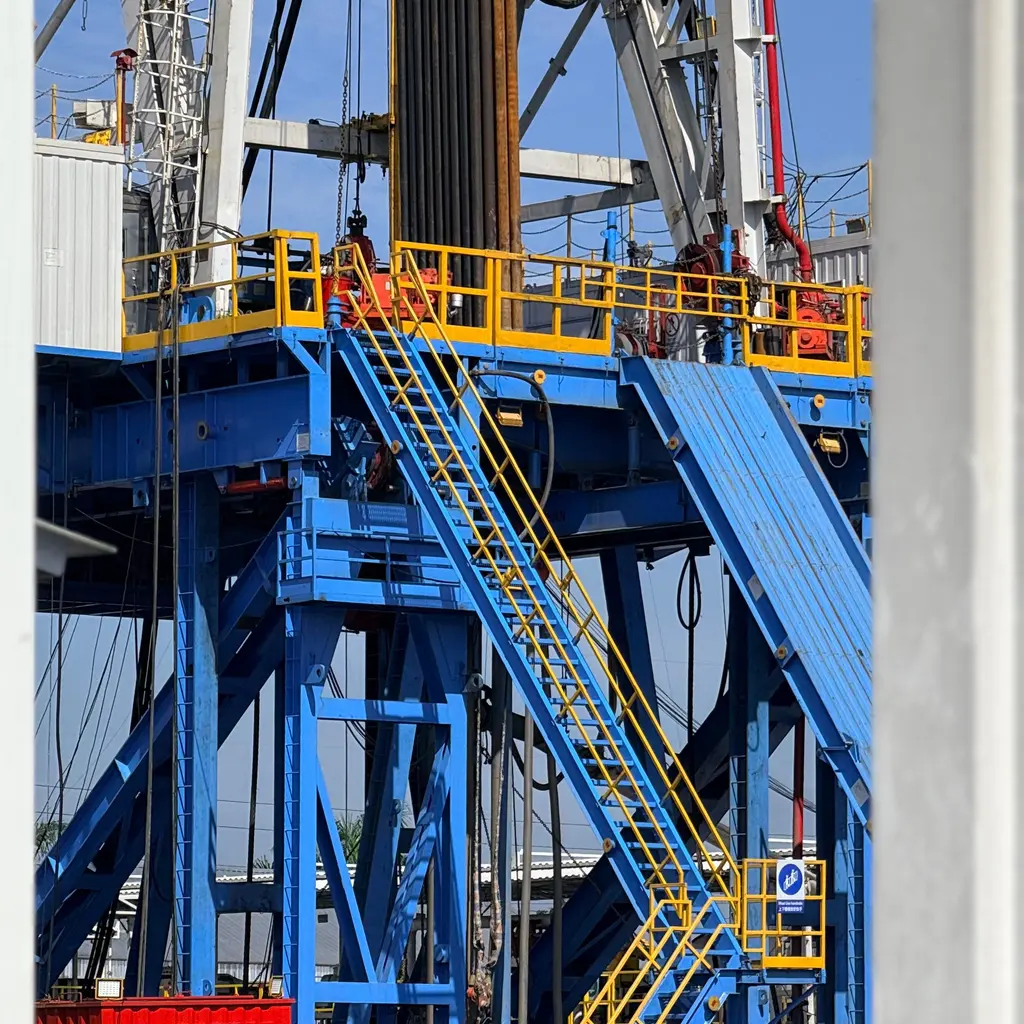 A land drilling rig's substructure, drill equipment and access stairs.