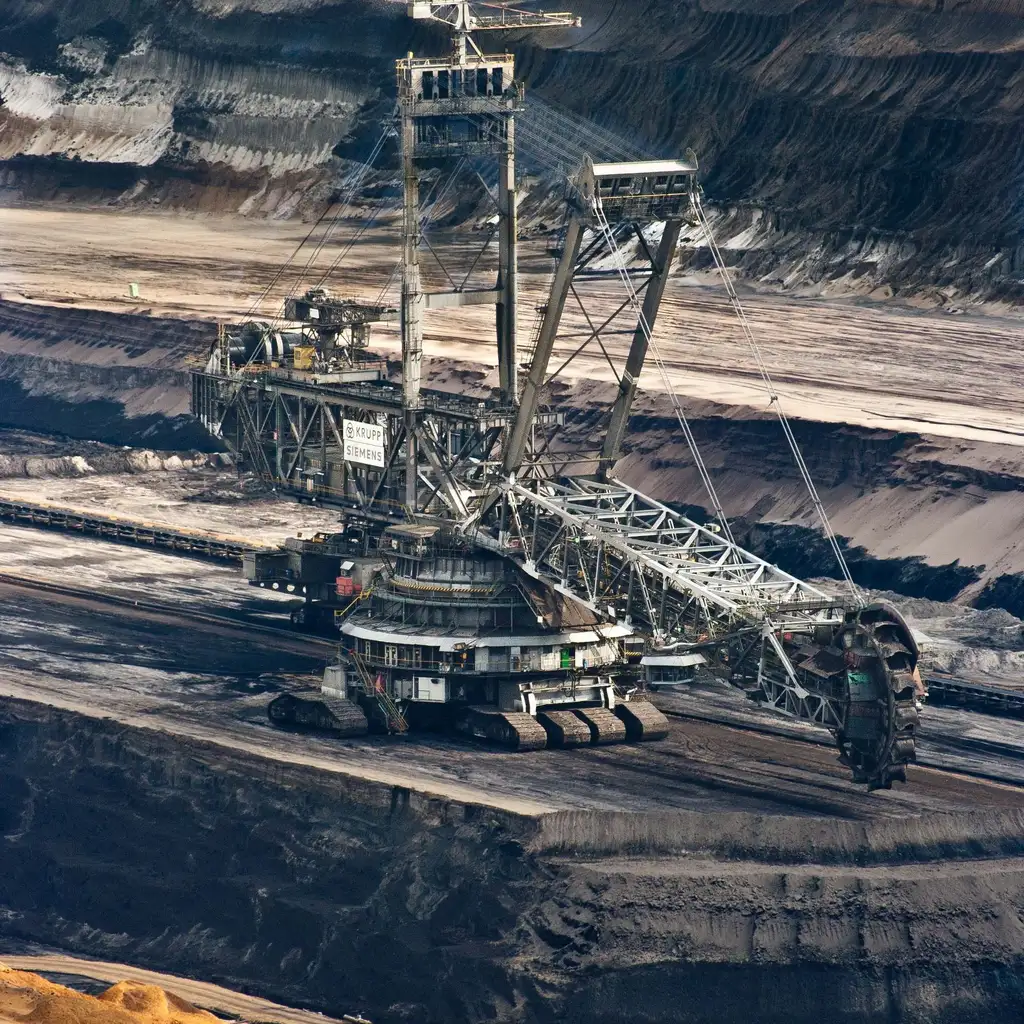 A bucket-wheel excavator and conveyor in an open-pit coal mine.
