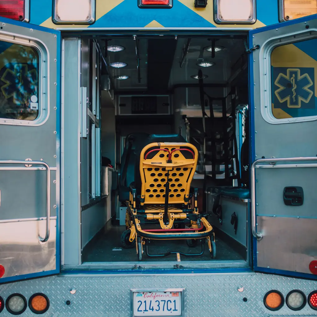 An empty transport stretcher in the rear of an ambulance.