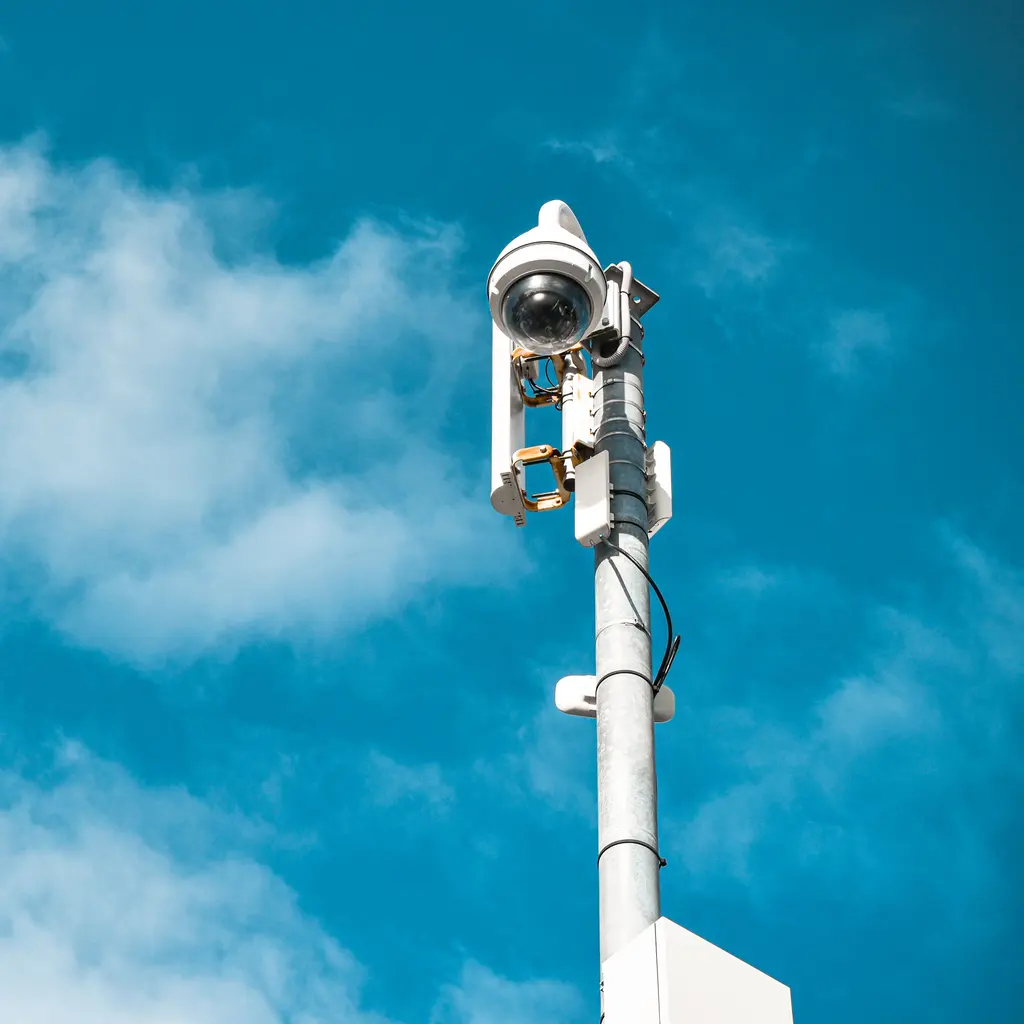 A surveillance camera mounted on a pole.