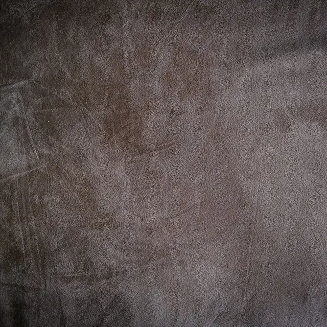 Close-up of the nap and surface texture of brown suede.