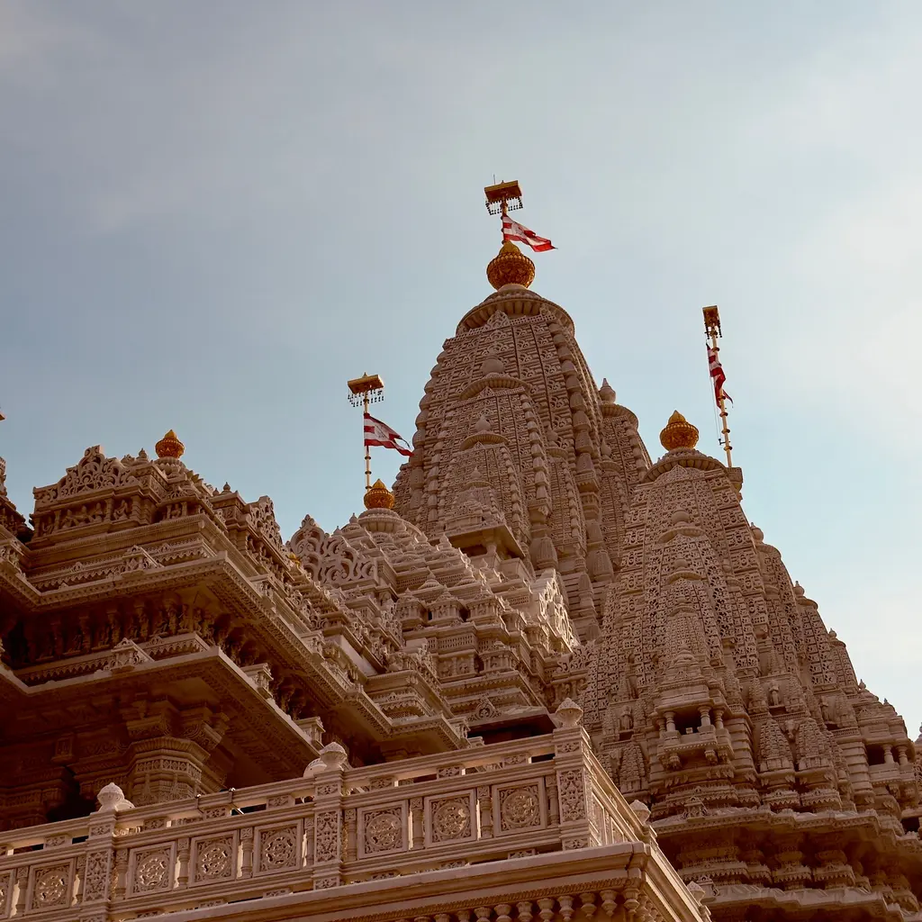 Carved towers and decorative stonework on the exterior of a Hindu temple.