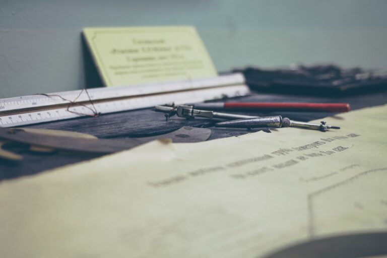 Tools and documents on a desk, symbolizing Group Benefits Compliance: Avoid Costly Legal Mistakes.
