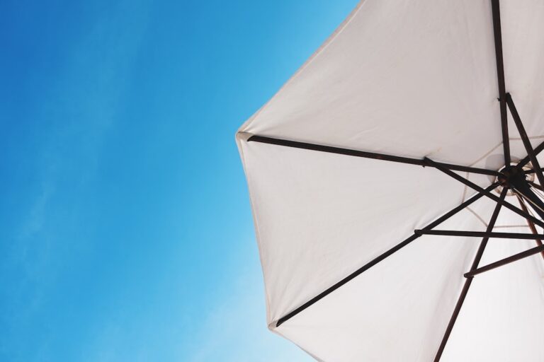 "White umbrella against a blue sky representing how life insurance can strengthen your retirement plan."