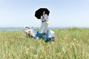 A person stands on a colorful structure in a field, pondering, "Is Your Health Insurance Disaster-Ready? Find Out Now."