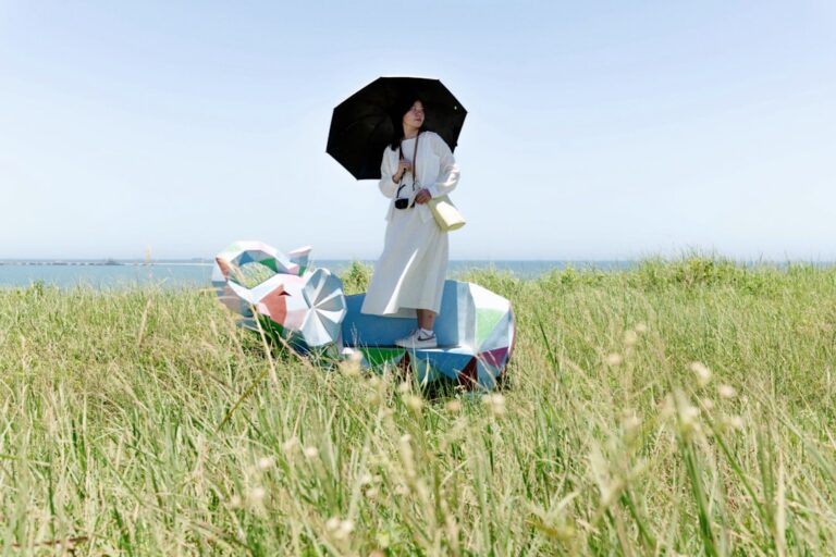 A person stands on a colorful structure in a field, pondering, "Is Your Health Insurance Disaster-Ready? Find Out Now."