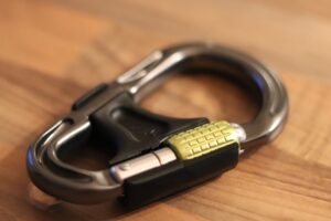 "Teen Auto Insurance: Smart tips for parents and new drivers with a carabiner on a wooden surface."