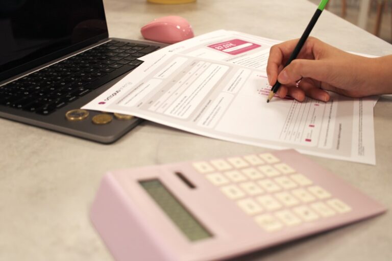 Person reviewing life insurance options with a calculator, emphasizing the need to update your life insurance as your needs evolve.