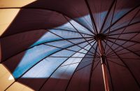 "Umbrella canopy illustrating protection, key to boosting retention with modern group benefits employees value."