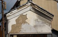 Damaged building exterior illustrating the need to protect your business from disasters with smart insurance.