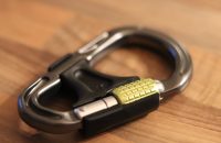"Teen Auto Insurance: Smart tips for parents and new drivers with a carabiner on a wooden surface."